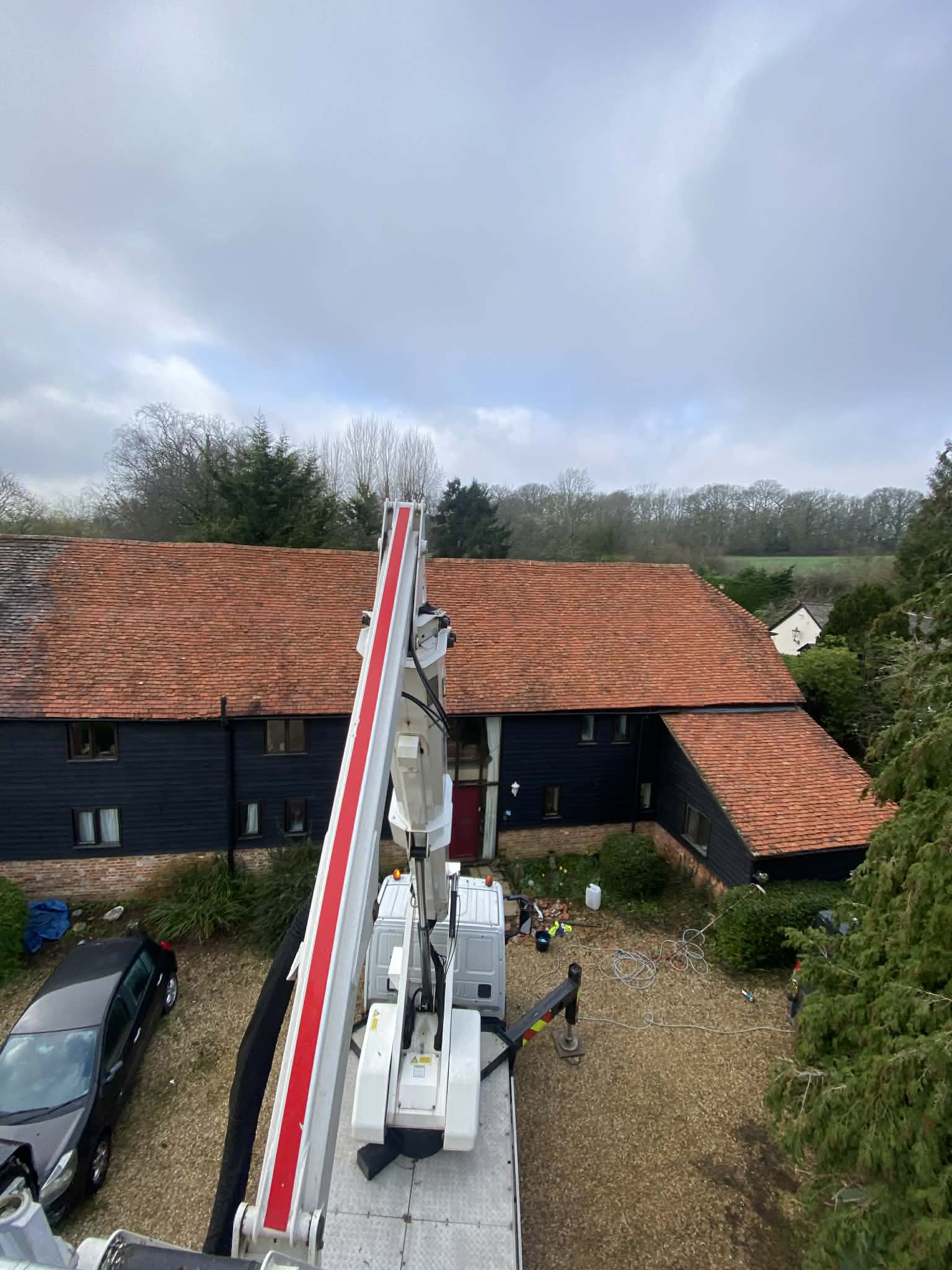 Chassis mounted Bronto access platform cleaning a delicate converted barn roof